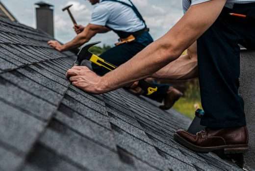 handyman repairing shingle roof